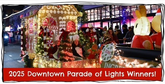 An image of two women riding a brightly lit float in the 2025 Downtown Parade of Lights