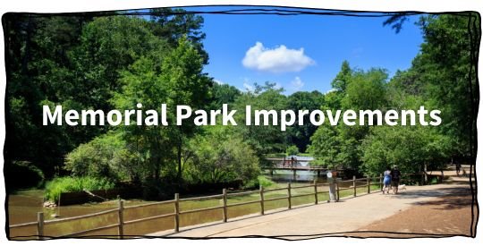 People walk down a path by the pond at Memorial Park