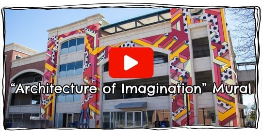 Brightly colored geometric mural on the side of a parking deck