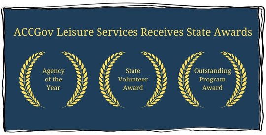 Gold text on a solid blue background noting three awards, each represented by gold wreaths