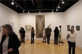 People gathered in a gallery at the 49th Juried Exhibition reception. 