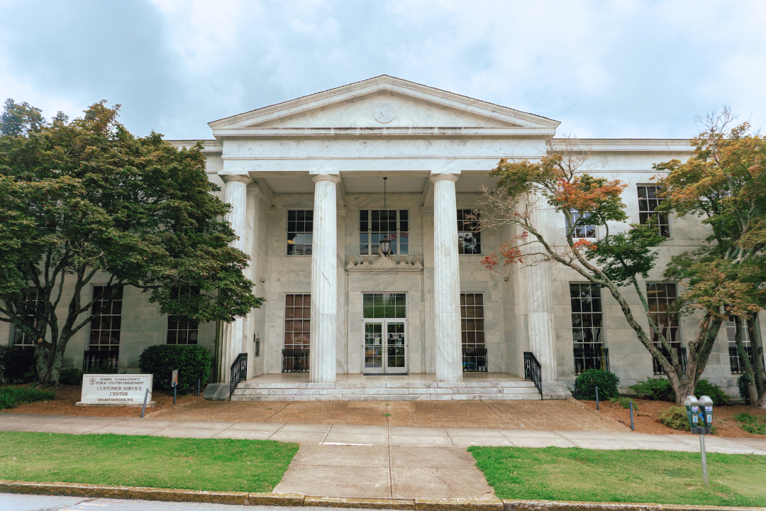 Water Busniess Office building. Large Columns in front of entrance and trees in front of building. 