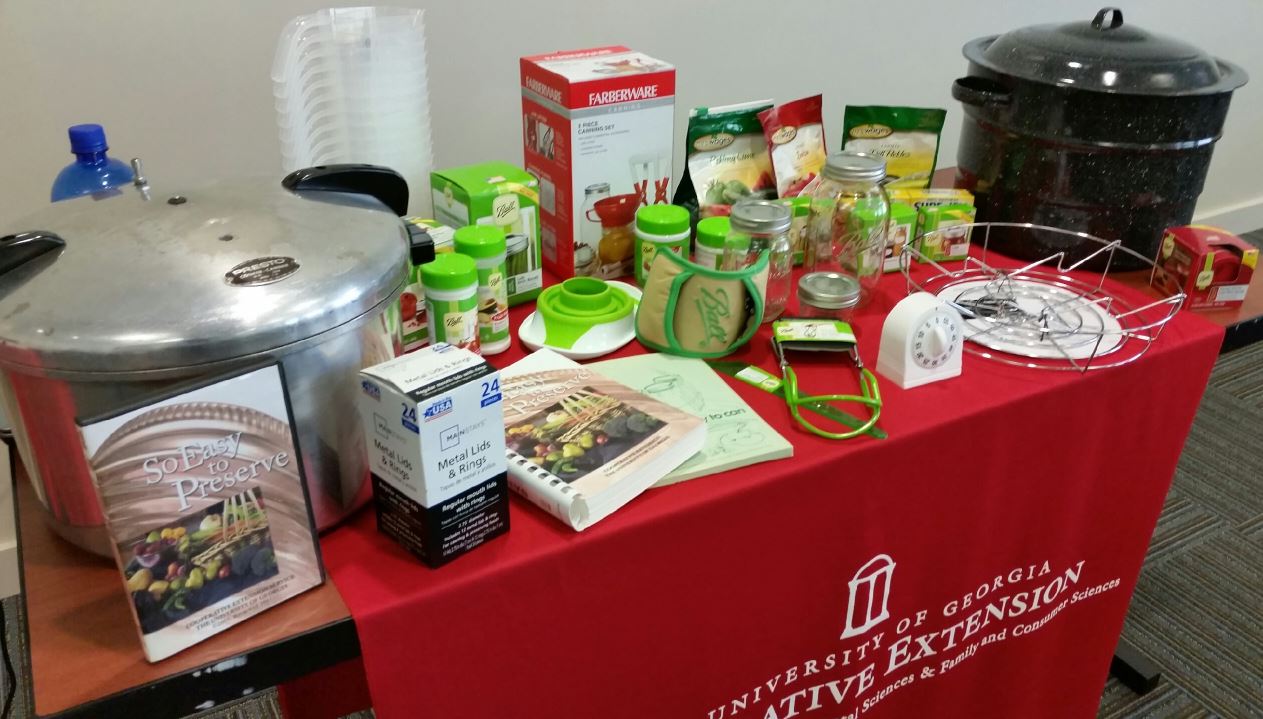 table top red tablecloth with kitchen supplies on top