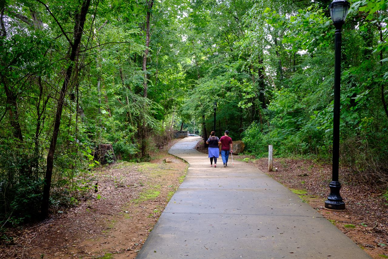 Couple walks on paved greenway 