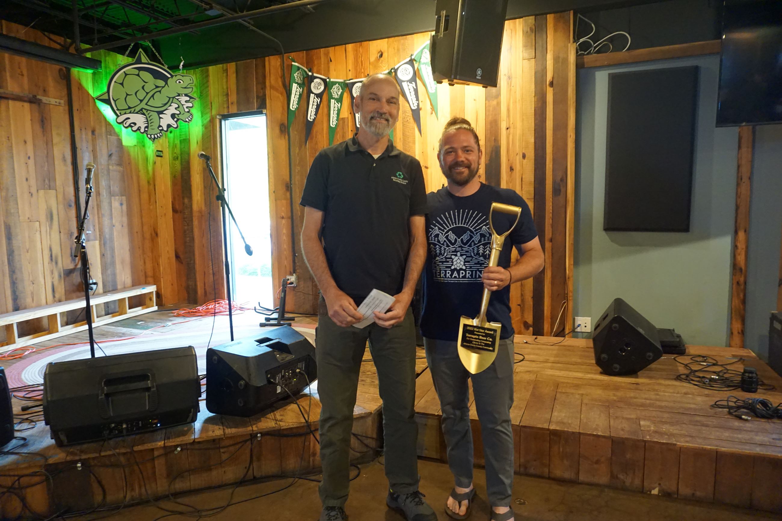 Dustin Watts on behalf of Terrapin receives the 2022 Rot Award for Composting from Joe Dunlop