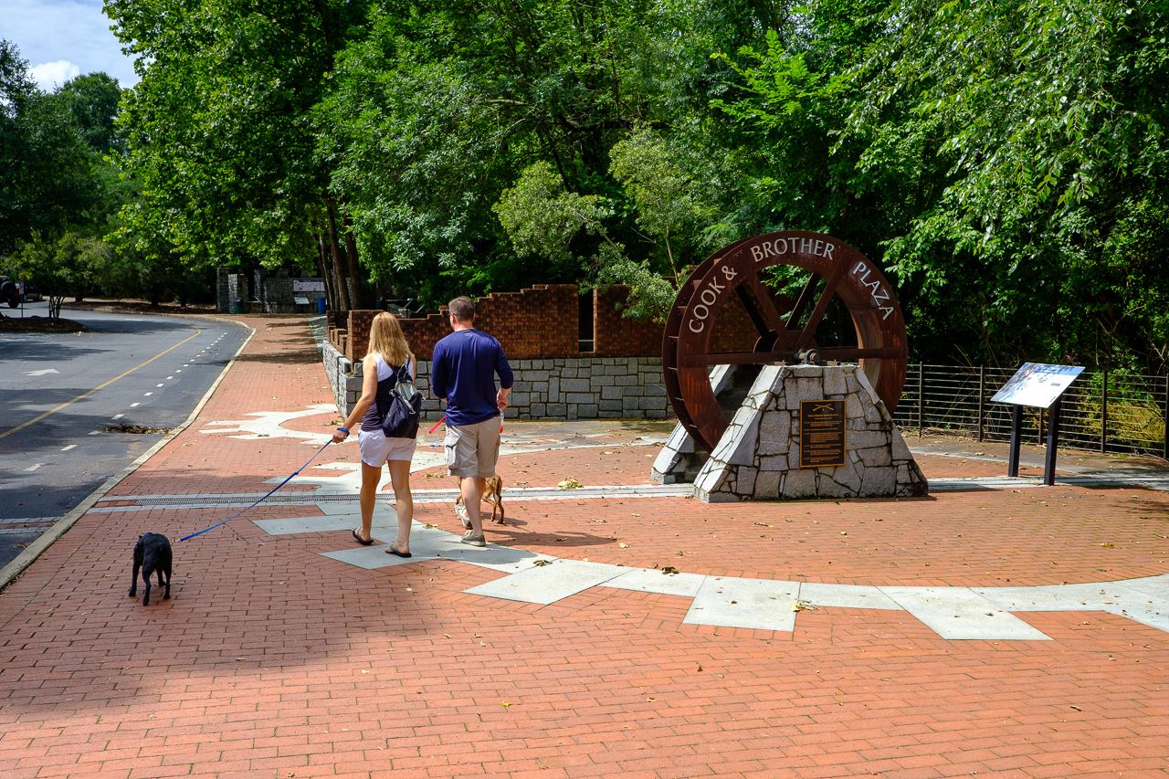 Large brick plaza with antique gear from mill operation