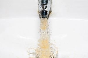 Discolored, brown water coming from a faucet